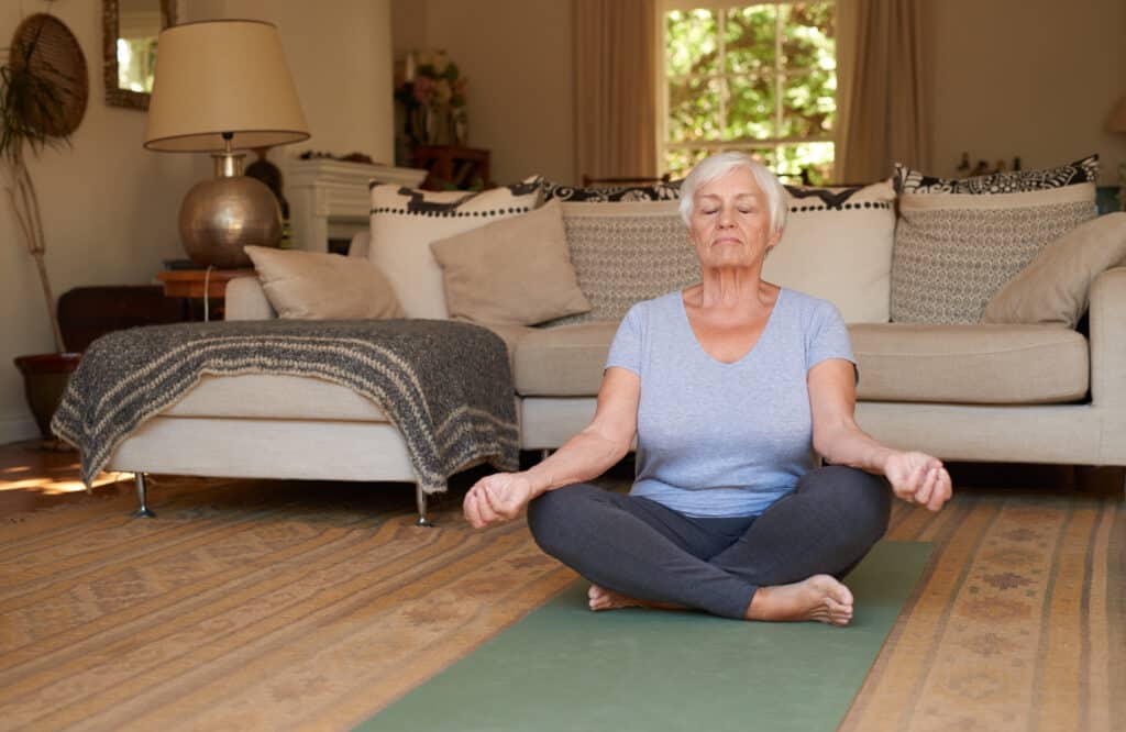 active,and,focused,senior,woman,sitting,in,the,lotus,pose
